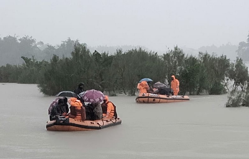 Barpeta: NDRF personal rescue flood affected villagers at Hallang Bari under Bajali revenue Circle in Barpeta district of Assam on July 11, 2020. (Photo: IANS)