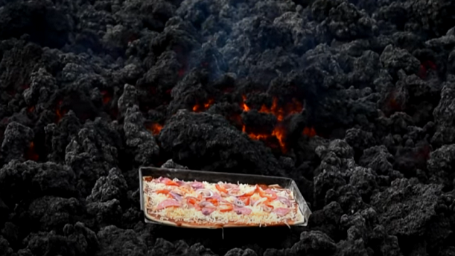 man cooks pizza on volcano