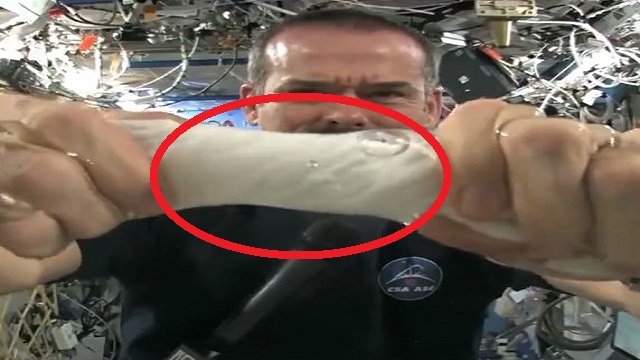 austronaut squeezes towel