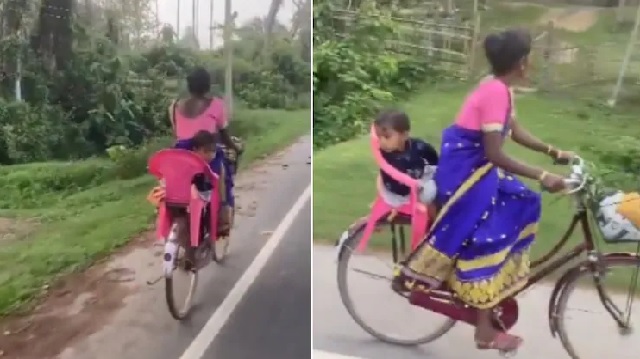 woman cycles with toddler on backseat