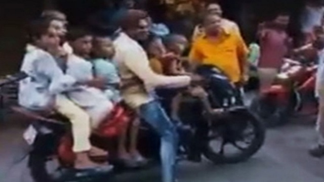 man with 7 children on bike