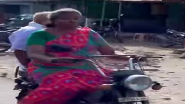 elderly woman rides moped
