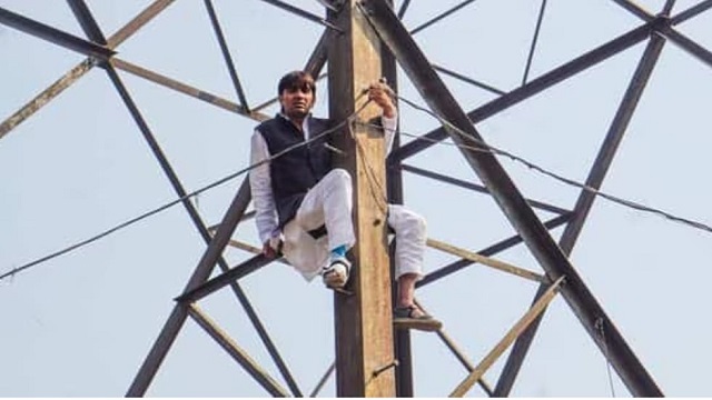 ex-AAP councillor climbs atop transmission tower