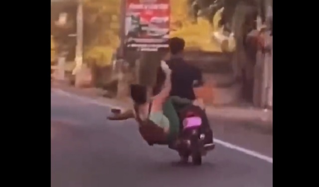 girl falls off bike after kicking another