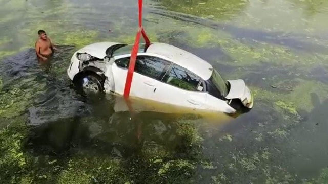 car falls into pond