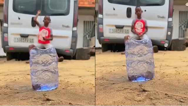 little boy throws stones in bottle