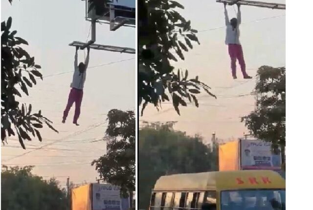 Drunken man hangs from billboard frame