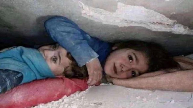 Syrian girl protects younger brother