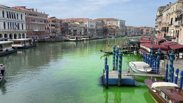 Water in Venice canal turns fluorescent green