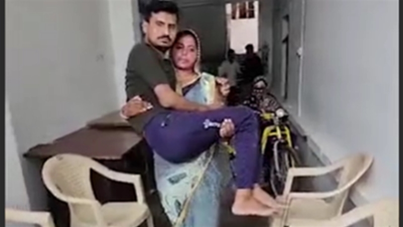 Woman carries disabled husband