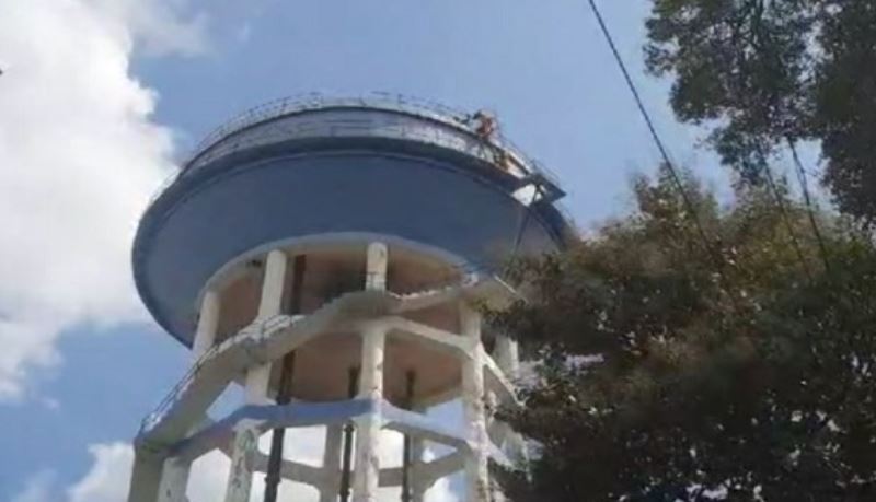 Youth climbs atop water tank