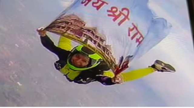 woman skydives with flag