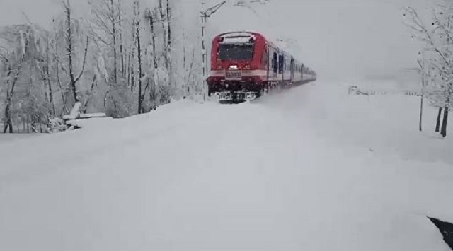train passing through snow in Kashmir